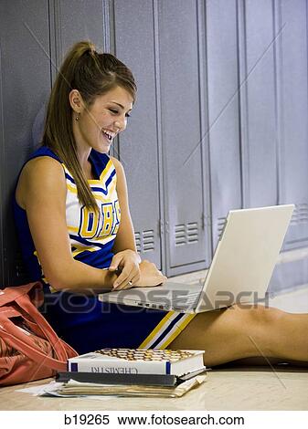Stock Photography - cheerleader in a school hallway. Fotosearch