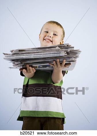 child holding a stack of newspapers View Large Photo Image Stock Image - child holding a stack of newspapers. Fotosearch