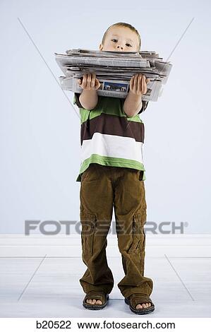 child holding a stack of newspapers View Large Photo Image Stock Image - child holding a stack of newspapers. Fotosearch