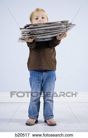 child holding a stack of newspapers View Large Photo Image Stock Photo - child holding a stack of newspapers. Fotosearch