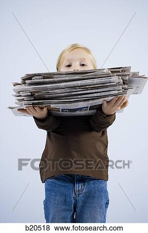 child holding a stack of newspapers View Large Photo Image Stock Photo - child holding a stack of newspapers. Fotosearch