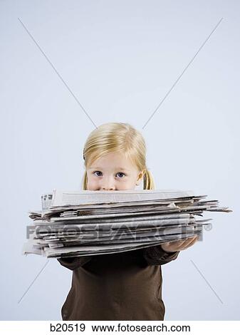 child holding a stack of newspapers View Large Photo Image Stock Photo - child holding a stack of newspapers. Fotosearch