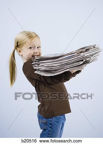 child holding a stack of newspapers View Large Photo Image Stock Photograph - child holding a stack of newspapers. Fotosearch