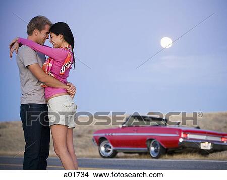 Picture - couple under a full moon. Fotosearch