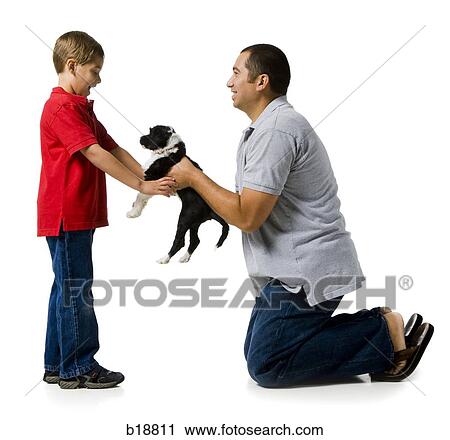 dad giving his son a puppy. View Large Photo Image Stock Image - dad giving his son a puppy.. Fotosearch