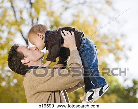 dad lifting baby boy in the air View Large Photo Image Stock Photo - dad lifting baby boy in the air. Fotosearch