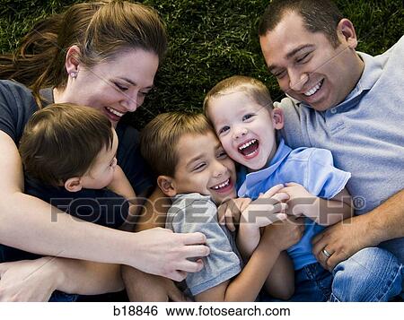 Family lying on the grass. View Large Photo Image Stock Photograph - Family lying on the grass.. Fotosearch