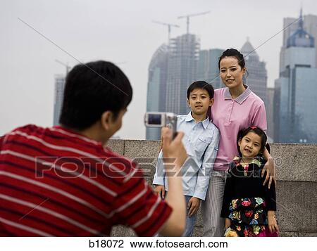 Family of four taking a picture. View Large Photo Image Stock Image - Family of four taking a picture.. Fotosearch