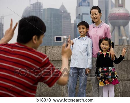 Family of four taking a picture. View Large Photo Image Stock Image - Family of four taking a picture.. Fotosearch