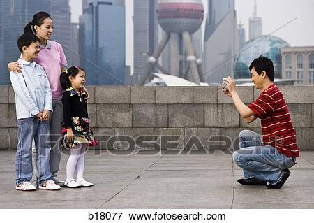 Family of four taking a picture. View Large Photo Image Stock Photo - Family of four taking a picture.. Fotosearch
