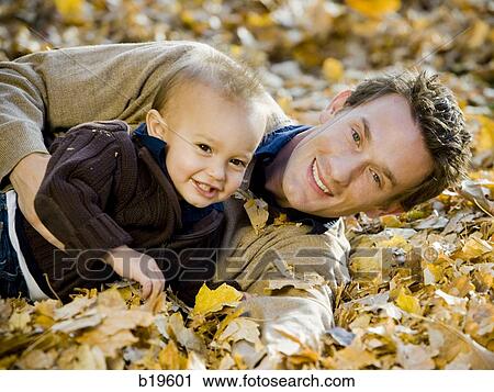 father and baby boy in leaves View Large Photo Image Stock Image - father and baby boy in leaves. Fotosearch