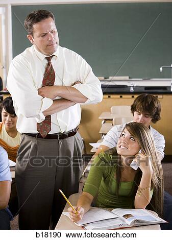 Female Student and teacher in a classroom. View Large Photo Image Stock Image - Female Student and teacher in a classroom.. Fotosearch