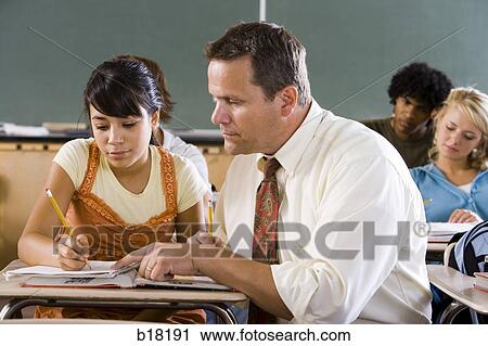 Stock Image - Female Student and teacher in a classroom.. Fotosearch