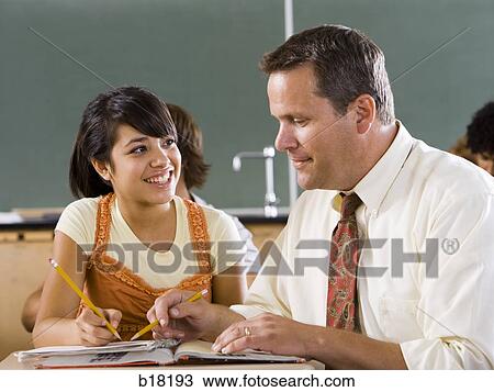 Female Student and teacher in a classroom. View Large Photo Image Stock Image - Female Student and teacher in a classroom.. Fotosearch