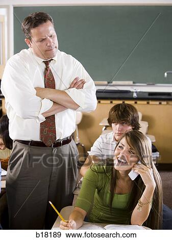 Stock Photo - Female Student and teacher in a classroom.. Fotosearch