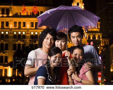 Five young people under an umbrella. View Large Photo Image Stock Image - Five young people under an umbrella.. Fotosearch