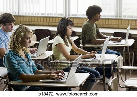 Four students working on notebook computers. View Large Photo Image Stock Image - Four students working on notebook computers.. Fotosearch