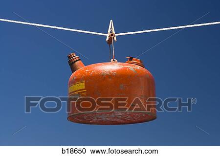 Stock Image - Gas can on a clotes line.. Fotosearch