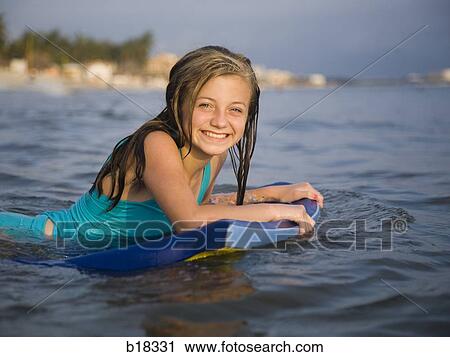 Girl in the water with surfboard. View Large Photo Image Stock Image - Girl in the water with surfboard.. Fotosearch