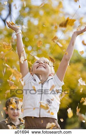 girl playing in fallen leaves. View Large Photo Image Picture - girl playing in fallen leaves.. Fotosearch