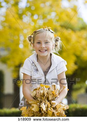 girl playing in fallen leaves. View Large Photo Image Stock Photo - girl playing in fallen leaves.. Fotosearch