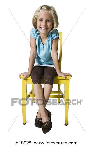 girl sitting in a yellow chair. View Large Photo Image Stock Photography - girl sitting in a yellow chair.. Fotosearch