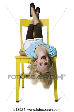 girl upside down in a yellow chair. View Large Photo Image Picture - girl upside down in a yellow chair.. Fotosearch