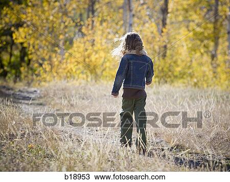 Stock Image - girl walking outside.. Fotosearch