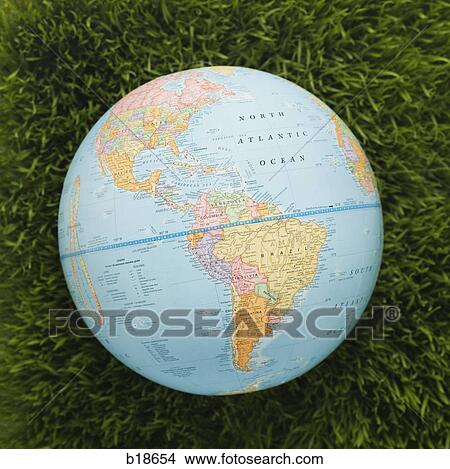 Picture - Globe against background of grass.. Fotosearch