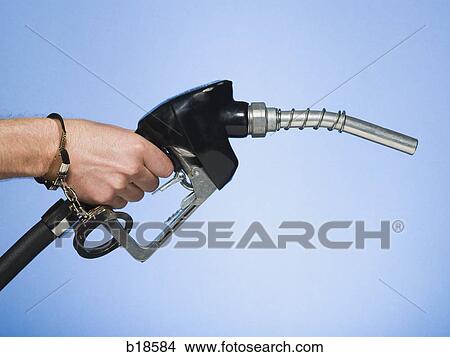 Hand handcuffed to a gas pump. View Large Photo Image Picture - Hand handcuffed to a gas pump.. Fotosearch