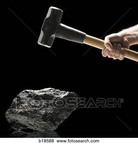 Hand swinging a sledge hammer toward a piece of coal. View Large Photo Image Stock Photo - Hand swinging a sledge hammer toward a piece of coal.. Fotosearch
