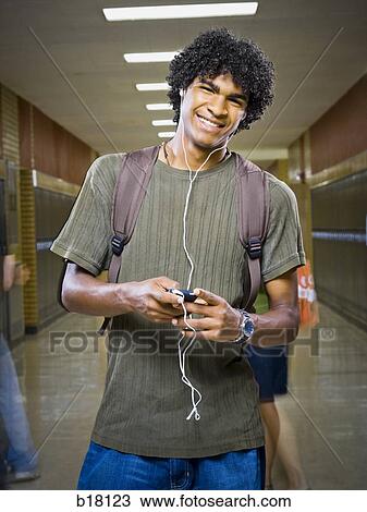 High School boy at school listening to MP3 player. View Large Photo Image Stock Image - High School boy at school listening to MP3 player.. Fotosearch