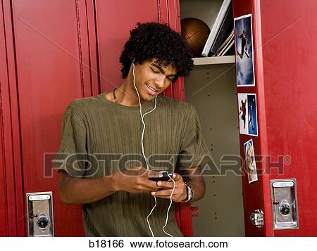 High School boy at school listening to MP3 player. View Large Photo Image Stock Photograph - High School boy at school listening to MP3 player.. Fotosearch