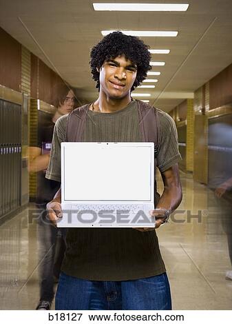 High School boy at school with a notebook computer. View Large Photo Image Stock Photo - High School boy at school with a notebook computer.. Fotosearch