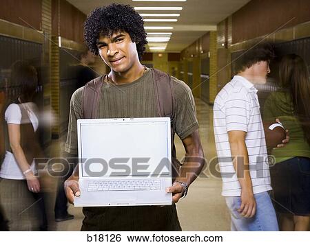 High School boy at school with a notebook computer. View Large Photo Image Stock Photograph - High School boy at school with a notebook computer.. Fotosearch