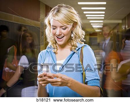 High School girl at school text messaging. View Large Photo Image Stock Image - High School girl at school text messaging.. Fotosearch