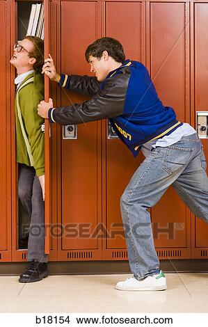 High school jock pushing nerd in locker. View Large Photo Image Picture - High school jock pushing nerd in locker.. Fotosearch