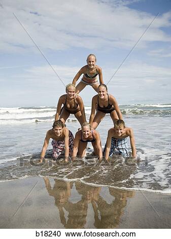 Human pyramid on the beach. View Large Photo Image Stock Image - Human pyramid on the beach.. Fotosearch