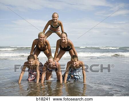 Human pyramid on the beach. View Large Photo Image Stock Image - Human pyramid on the beach.. Fotosearch