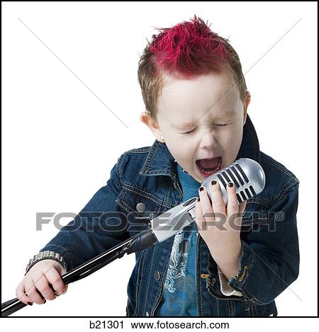 Stock Image - little boy singing into a microphone. Fotosearch