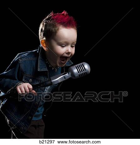 Stock Photo - little boy singing into a microphone. Fotosearch