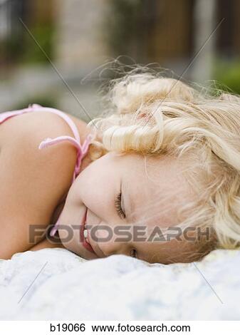 little girl lying on a blanket. View Large Photo Image Stock Photograph - little girl lying on a blanket.. Fotosearch