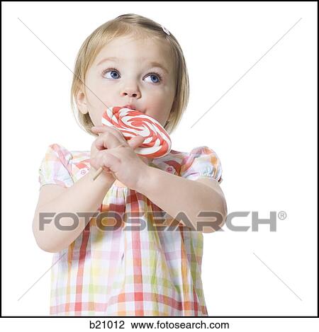 Stock Image - little girl with a lollipop. Fotosearch