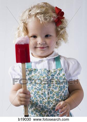 Stock Image - little girl with a spatula.. Fotosearch