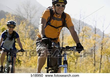 Male and female mountain bikers. View Large Photo Image Stock Image - Male and female mountain bikers.. Fotosearch