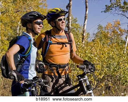 Stock Image - Male and female mountain bikers.. Fotosearch