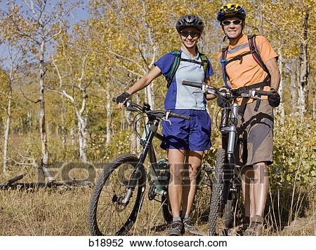 Male and female mountain bikers. View Large Photo Image Stock Image - Male and female mountain bikers.. Fotosearch