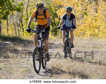Male and female mountain bikers. View Large Photo Image Stock Photo - Male and female mountain bikers.. Fotosearch