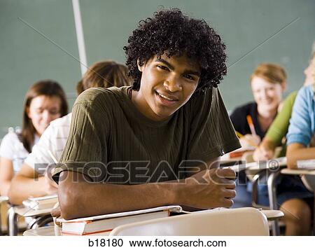 Male student in a classroom. View Large Photo Image Stock Image - Male student in a classroom.. Fotosearch