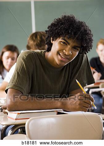 Male student in a classroom. View Large Photo Image Stock Image - Male student in a classroom.. Fotosearch